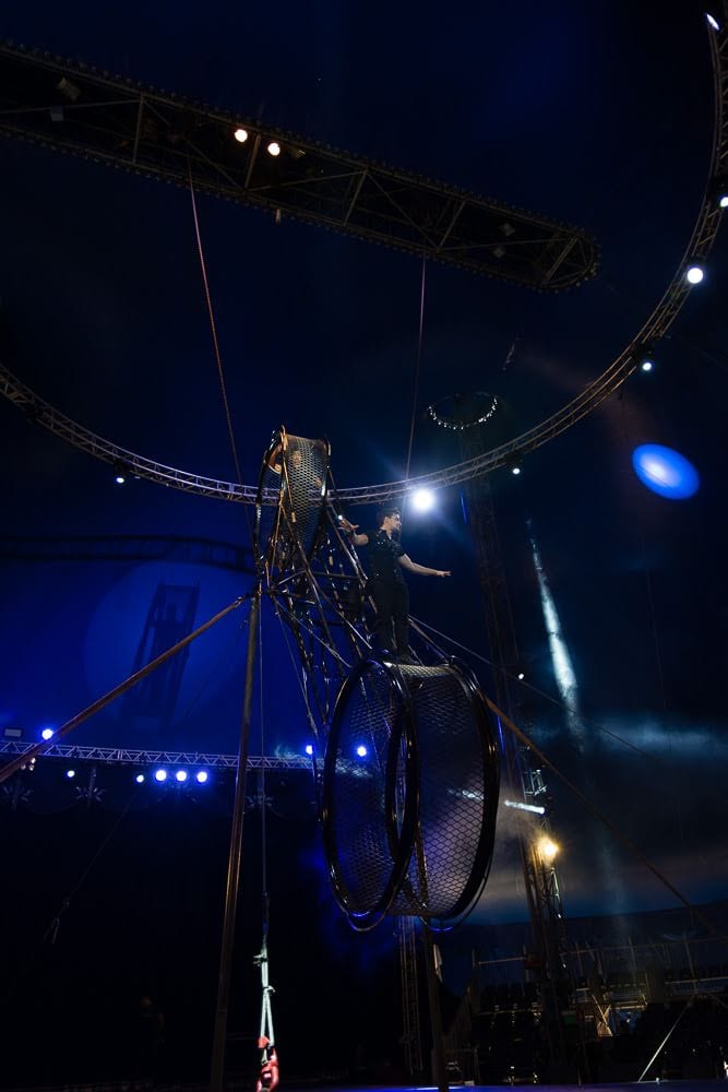 Rodrigo Gomez on the wheel under stage light, Le Cirque Amar.